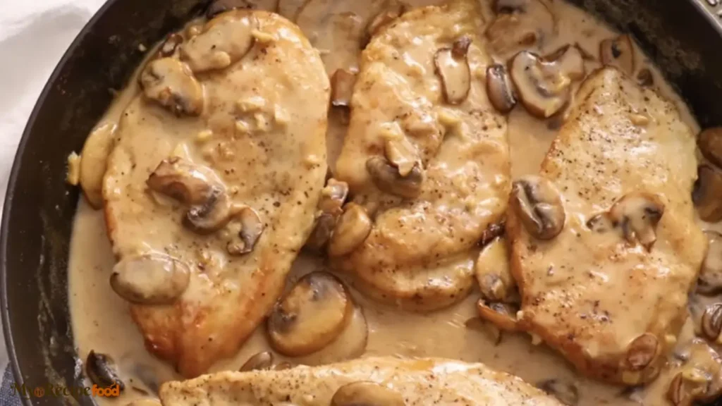 Creamy Chicken Marsala with golden brown chicken cutlets smothered in rich mushroom wine sauce, served over pasta